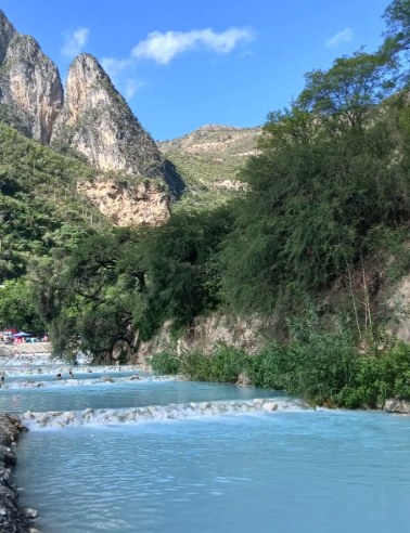 The thermal river at Grutas Tolantongo below the limestone peaks of the Mezquital Valley