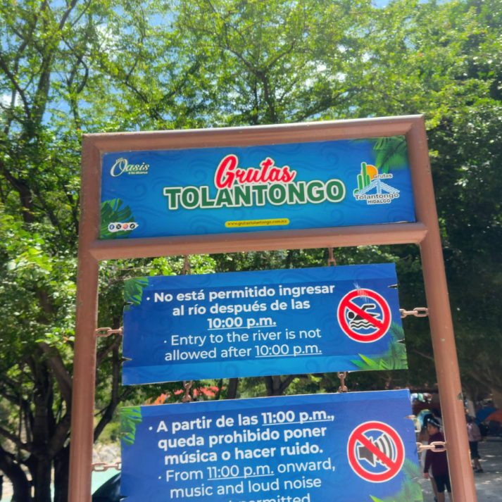 The bilingual visitor rules sign at the entrance to Grutas Tolantongo